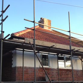 Scaffolding around a house to aid with roofing reapirs